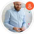 A circular profile image featuring a man with a beard and glasses