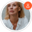 A circular profile picture of a blonde woman in a white shirt